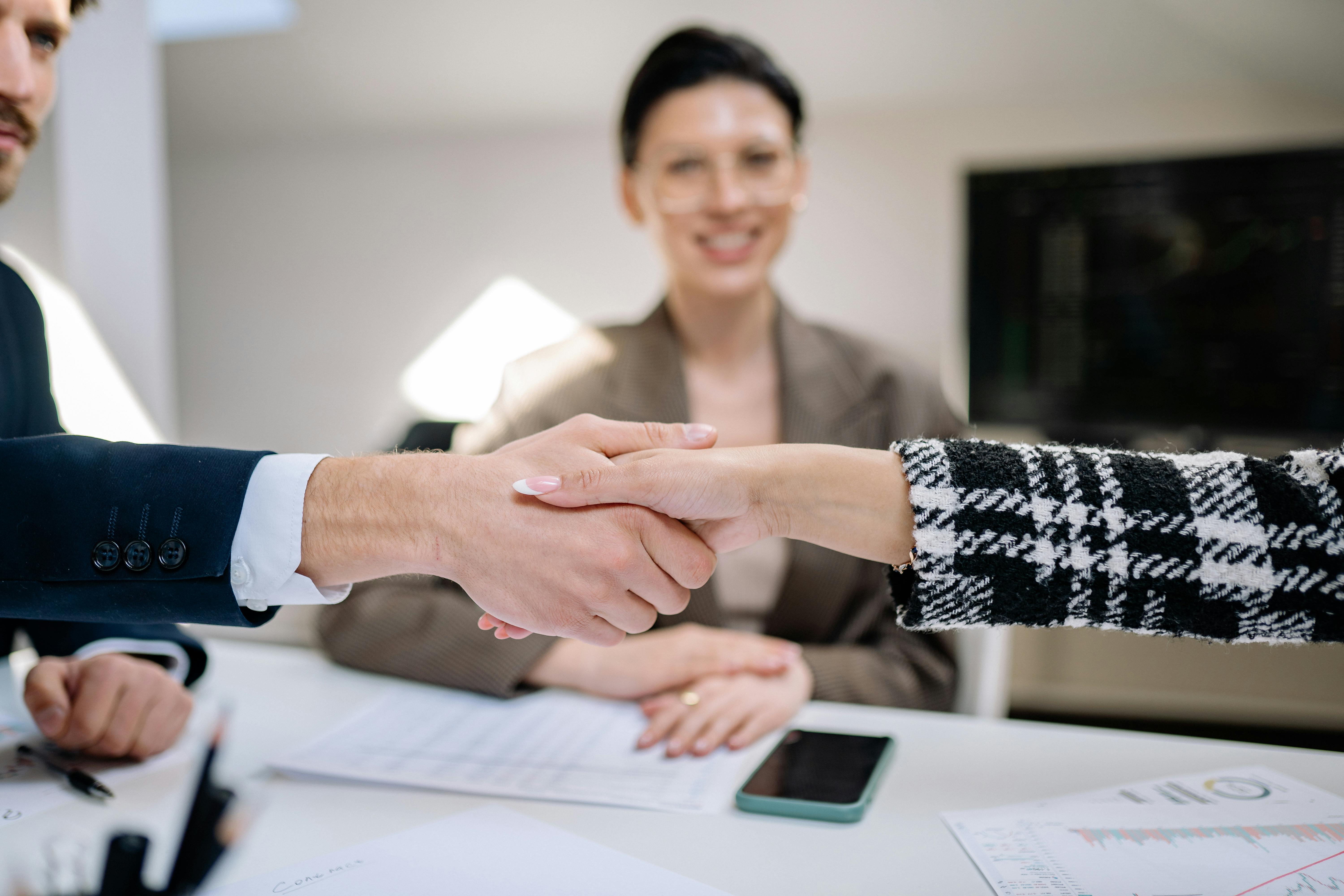 Business professionals shaking hands during a partnership meeting